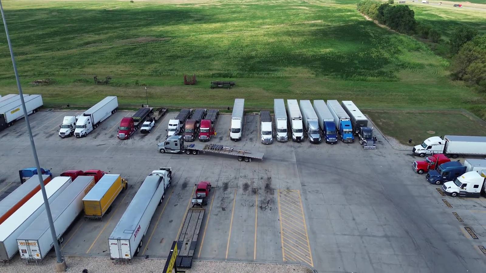 Aerial view of a container yard with tractors and trailers staged near the San Pedro Bay port complex